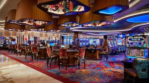 Tampilan layar pemain dengan statistik taruhan, riwayat hasil, dan opsi chat dealer di meja No Commission Baccarat